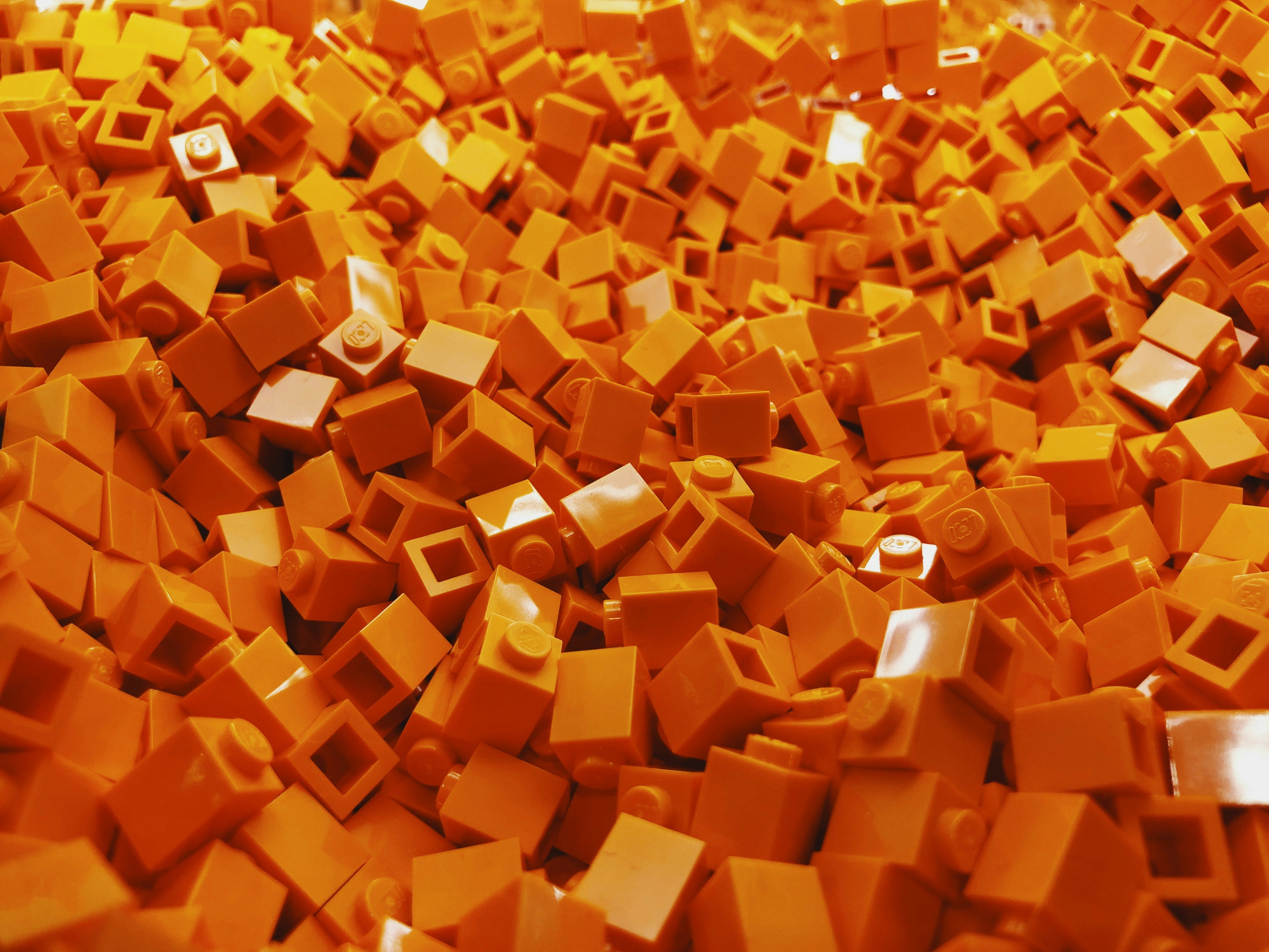 Close-up of orange building block texture – creative Beyond Bricks design background.