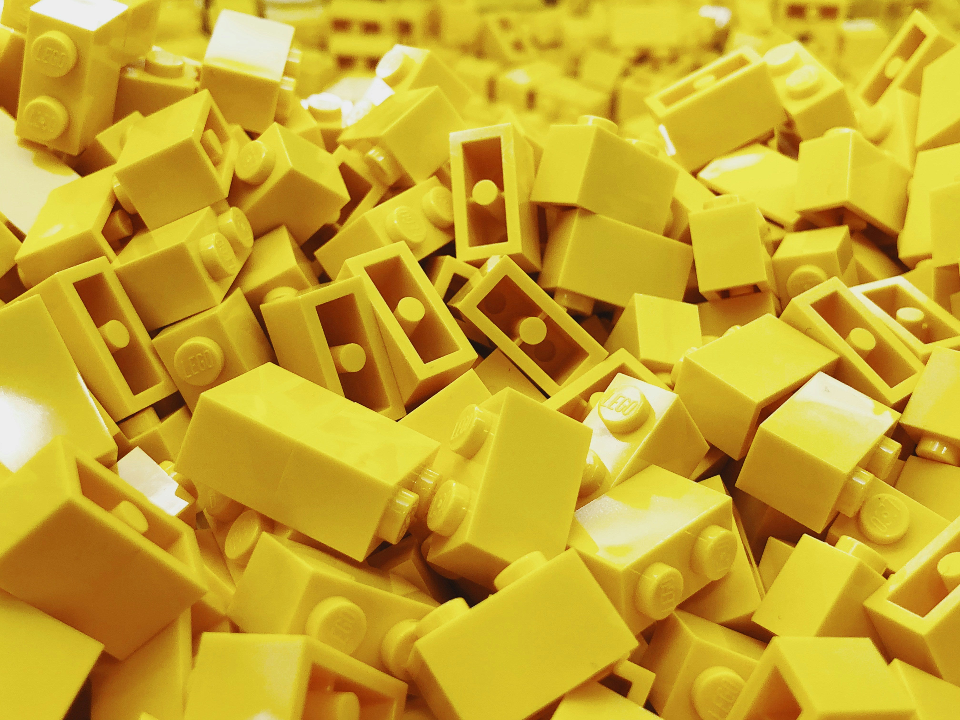 Bright yellow mini building blocks – colorful toy background for Beyond Bricks.