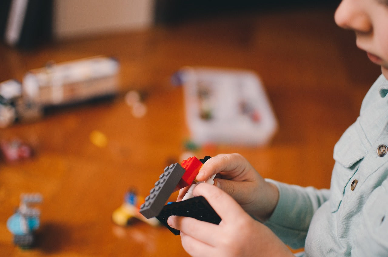 Child playing with mini building blocks – fun educational toys for all ages.