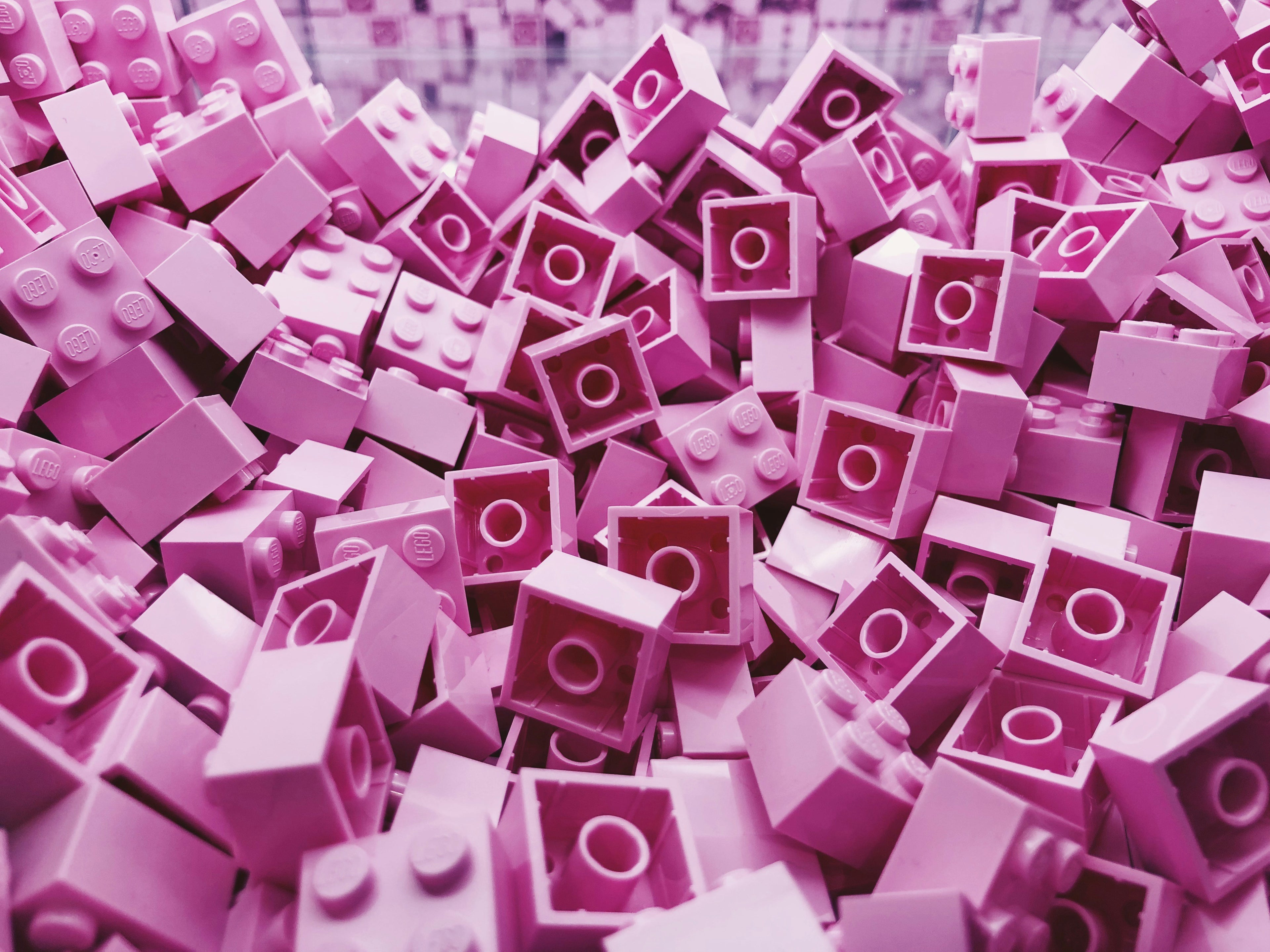 Pile of pink mini building blocks – fun and playful Beyond Bricks background.